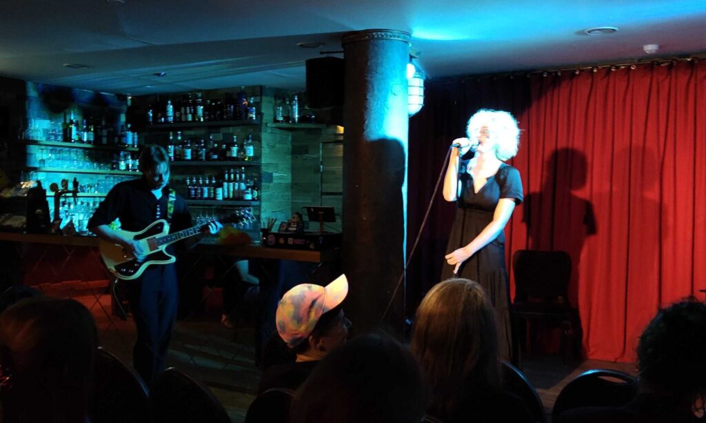 Sasha Paris-Carter sings while Lebo Sibul plays guitar.