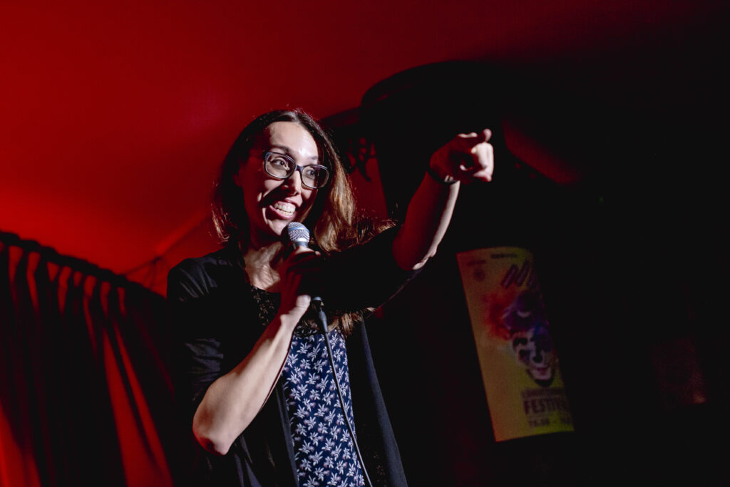 Erica Jean points into the audience in Mistranslated.