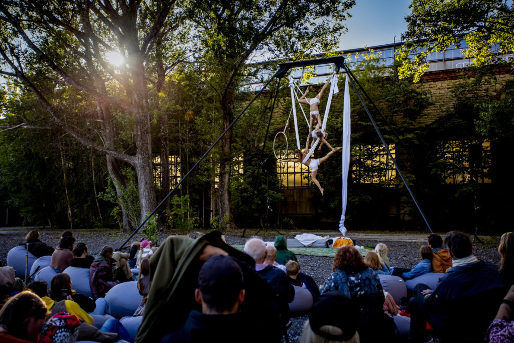 The Three Sisters perform aerial acrobatics together in front of a crowd in Krulli Kvartal.